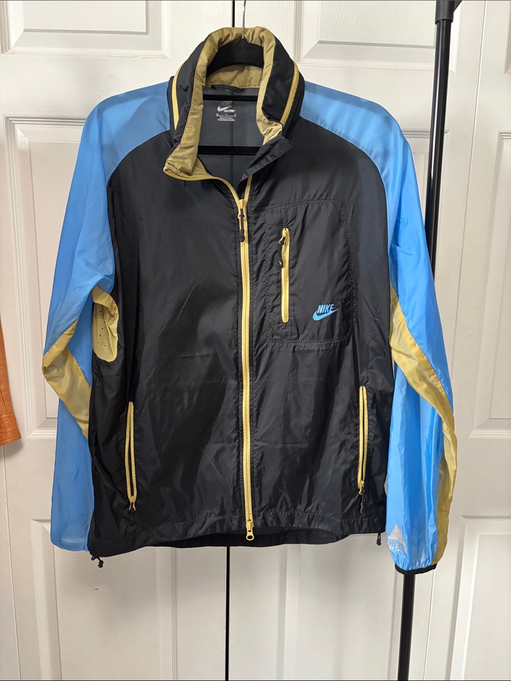 Nike Black Windbreaker Jacket with Light Blue Sleeves and Gold Trim